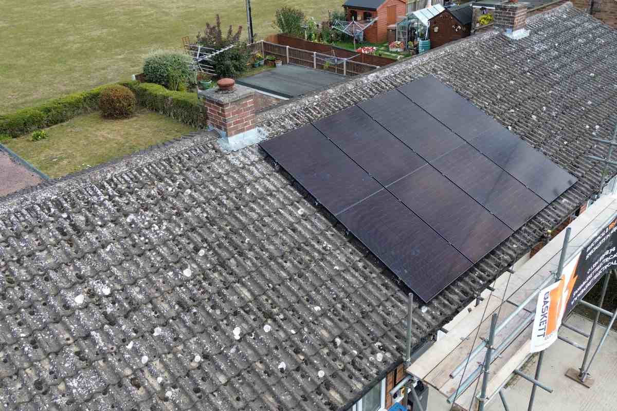 Eight all-black solar panels on a tiled pitched roof.