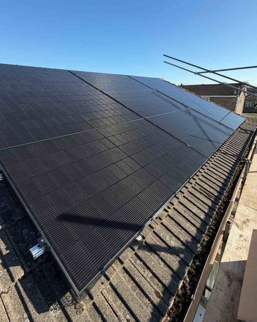 Finished all-black solar array on a tiled roof.