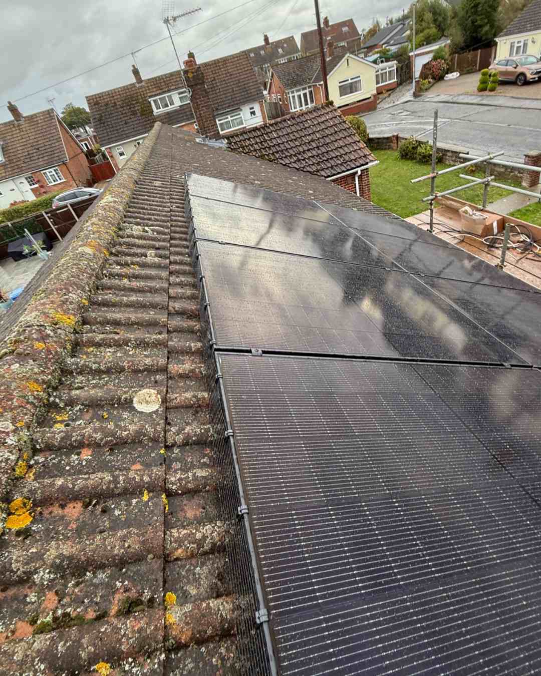 Solar array on a pitched roof on a residential street.